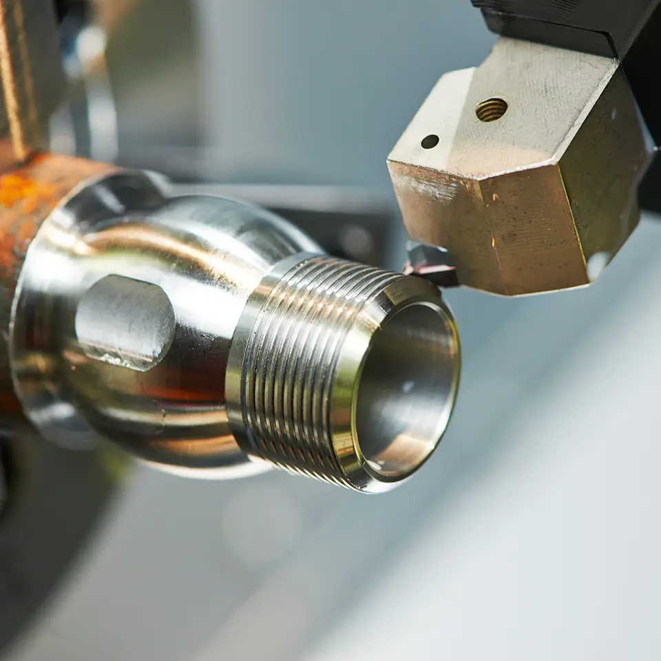CNC machine creating a threaded end part
